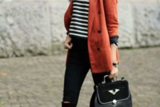 With striped crop shirt, black pants, boots and bag