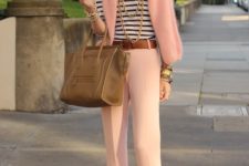 With striped shirt, brown belt, neutral shoes and big bag