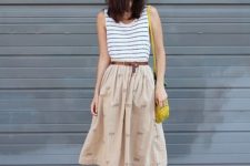 With striped top, A-line skirt and yellow bag