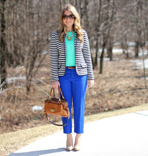 With turquoise shirt, striped jacket and brown bag