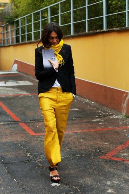 With white shirt, black jacket, yellow scarf and platform shoes