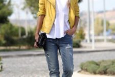 With white shirt, cuffed jeans, yellow jacket and clutch