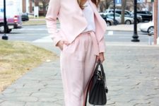 With white shirt, light pink jacket, pumps and black bag