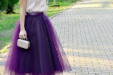 With white top, tulle skirt and mini bag