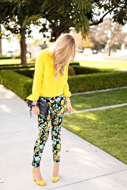 With yellow blouse, floral pants and black clutch