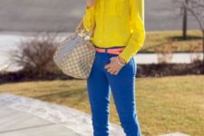 With yellow shirt, colorful belt, beige pumps and printed bag