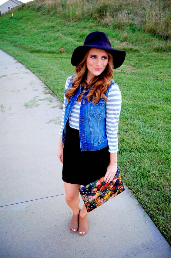 a black skirt, a striped shirt, a denim vest and nude boots