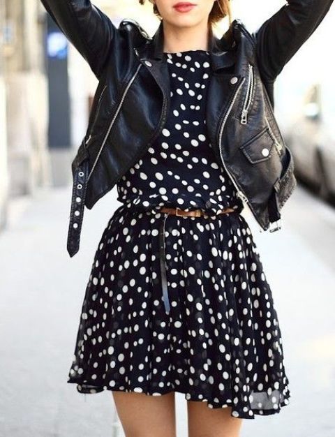 a navy and white polka dot dress with a brown belt and a black leather jacket