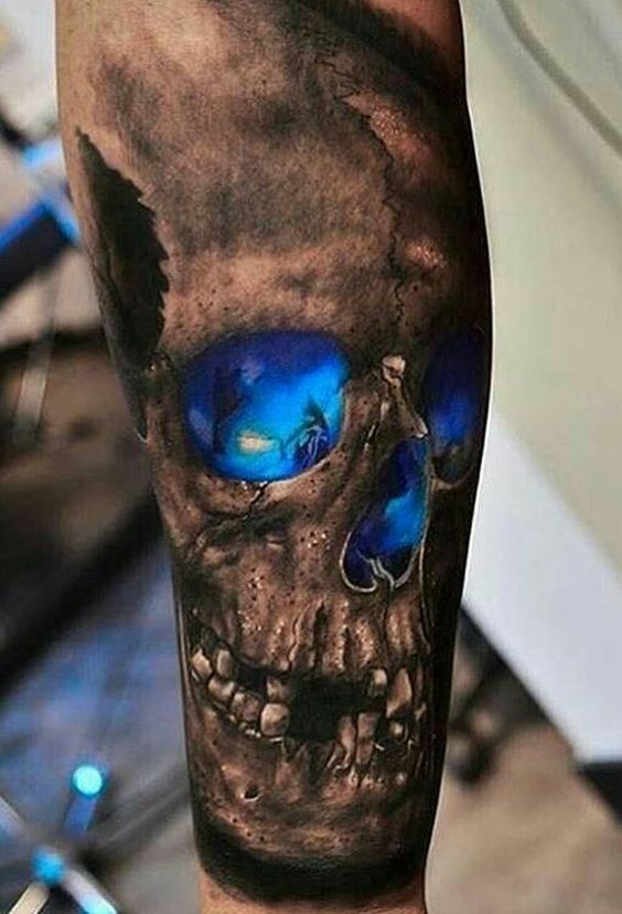 black and deep blue skull tattoo on an arm