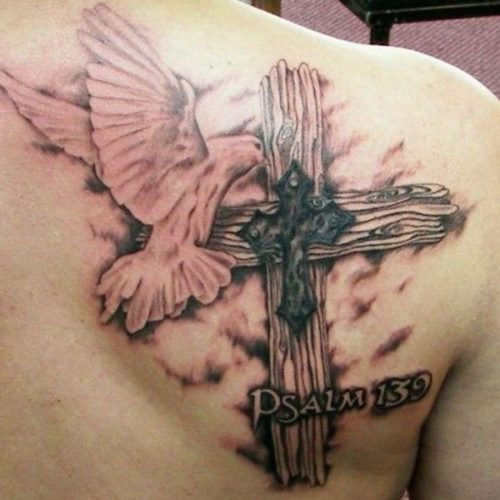 religious cross tattoo with a psalm number and a bird on a shoulder