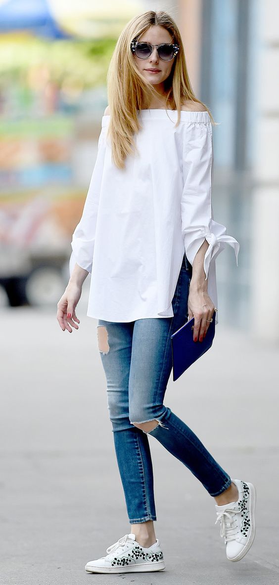 ripped jeans, a white off the shoulder and white sneakers