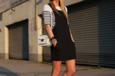 06 a black overall,a striped top and pointed black shoes