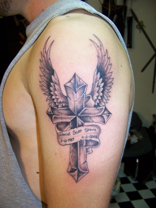 a large cross tattoo with wings in honor of a dead friend
