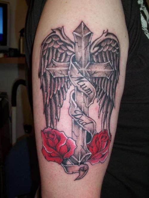 a metal cross tattoo with wings commemorating the dead