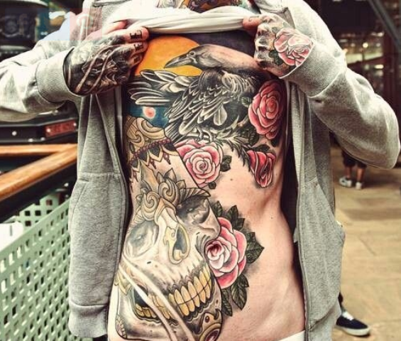 colorful skull tattoo with roses wrapped around