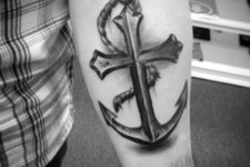 09 cross anchor tattoo with a memorable date on a forearm