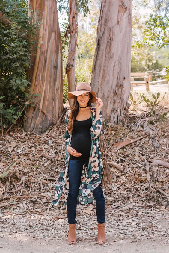 a long floral maternity kimono, jeans, a black top and brown boots