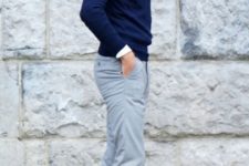 11 grey pants, a navy sweater, a white shirt and white sneakers