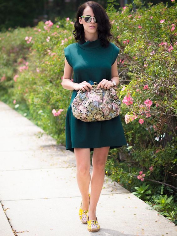 an emerald mini dress, bold loafers and a vintage floral handbag