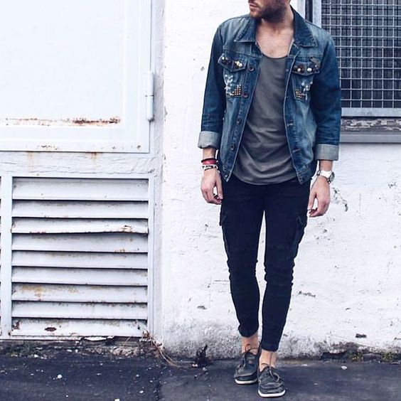 black pants, a grey tee, a denim jacket and brown moccasins