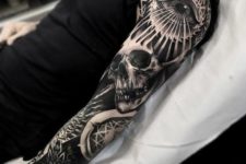 15 a whole sleeve tattoo with a skull and an eye