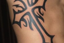 17 black ink cross body tattoo