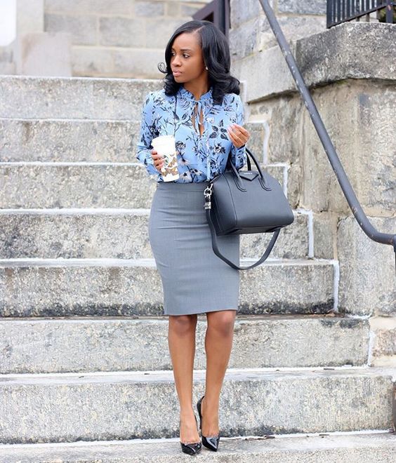 a grey knee skirt, a blue floral blouse and black shoes