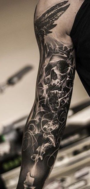 black and white sleeve tattoo with a skull