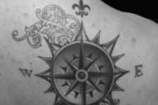 19 stylized black ink compass tattoo on a back