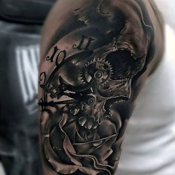 clock and skull melting tattoo on the shoulder
