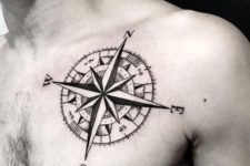 20 compass man tattoo on the body with black ink