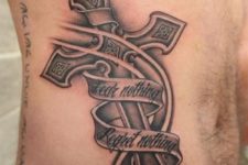 22 metal cross body tattoo with a meaningful quote