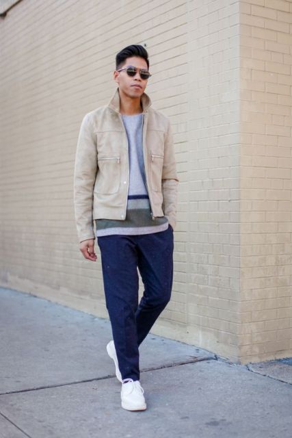 Beige jacket with striped shirt, navy blue pants and white sneakers