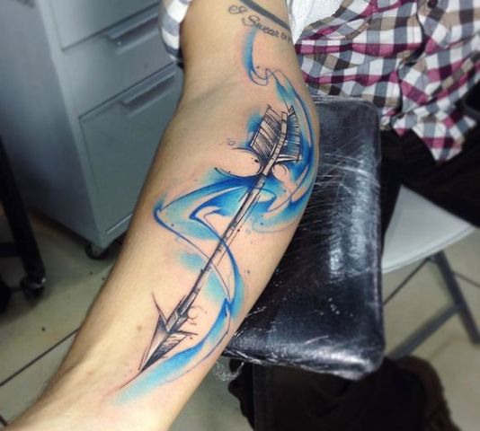 Blue color arrow tattoo on the arm