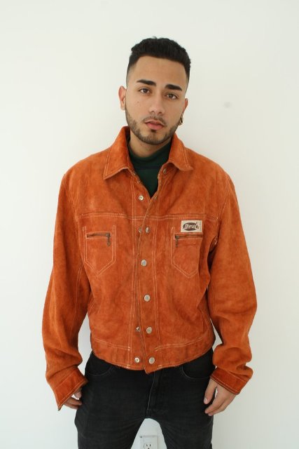 Orange jacket with green shirt and jeans