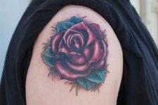Red rose with green leaves on the shoulder