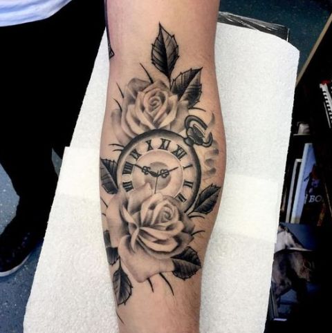 Roses with clock tattoo on the arm