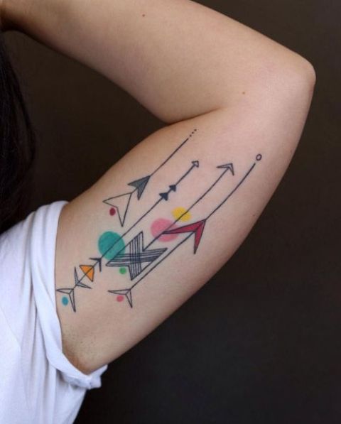 Several colorful tattoos on the left arm