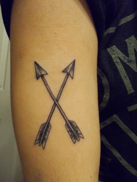 Two crossed arrows tattoo