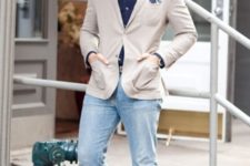 With beige blazer, light blue jeans and hat