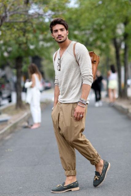 With beige loose shirt, brown leather backpack and loafers