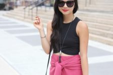 With black crop top and mini bag