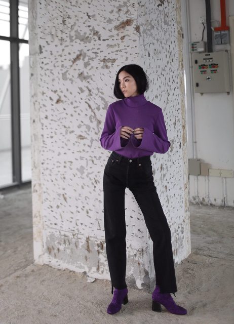 With black jeans and purple turtleneck