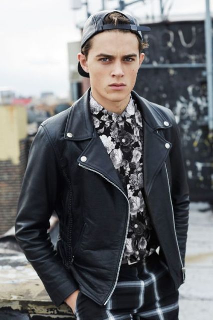 With black leather jacket, cap and printed trousers