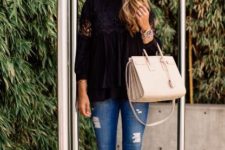 With black loose shirt, skinny jeans and white bag
