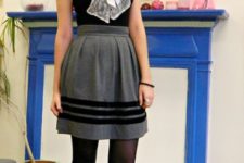 With black shirt with white bow, gray skirt and black tights