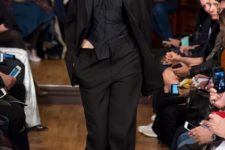 With black top, trousers and long blazer