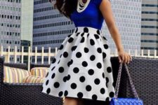 With blue shirt, polka dot skirt and necklace