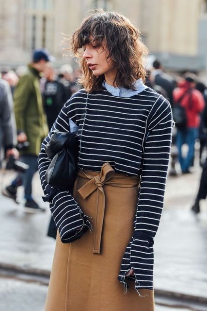 With blue shirt, striped shirt and black clutch