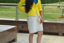 With blue shirt, white skirt, metallic shoes and clutch